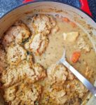 A stew pot with chicken and dumplings.