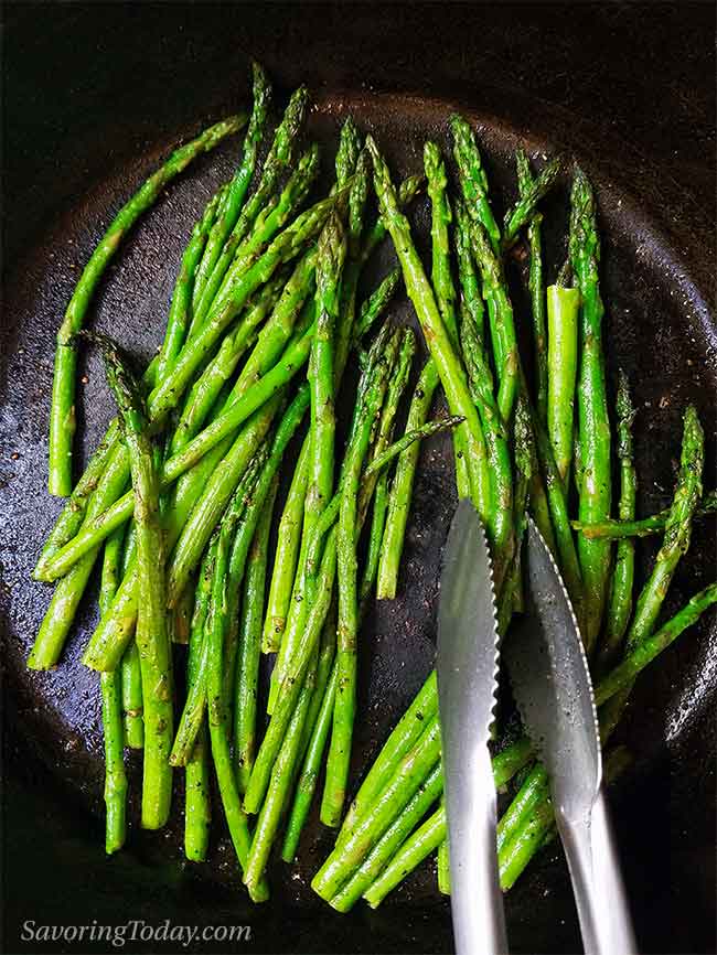 Asparagus roasted in a cast iron pan on top of the stove or in the oven. Roasted asparagus in a cast iron pan.